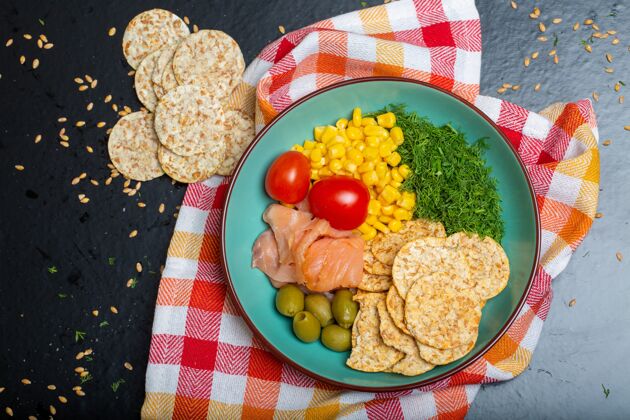 饮食一碗沙拉的特写镜头 桌上的餐巾上放着三文鱼 饼干和蔬菜餐巾纸新鲜晚餐