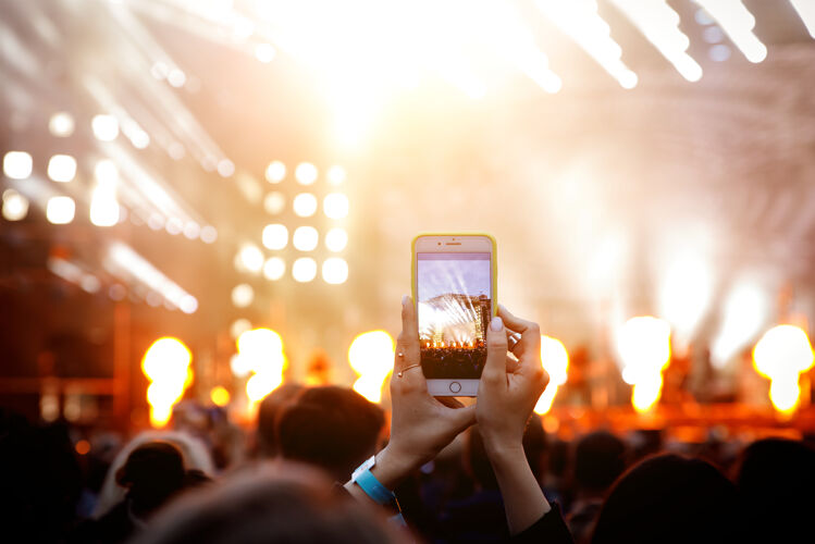 音乐会在音乐会上拍摄视频或照片手持智能手机许多节日拍摄